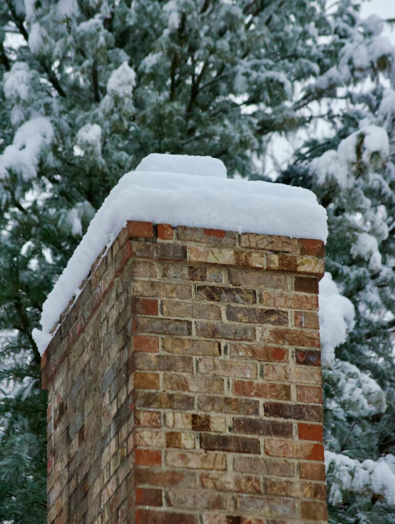 A code inspector examines roof flashing and attic ventilation on a snow-ready residential roof.