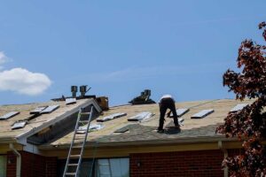 Homeowner reviews roof warranty papers beside photos and a small roof inspection checklist.